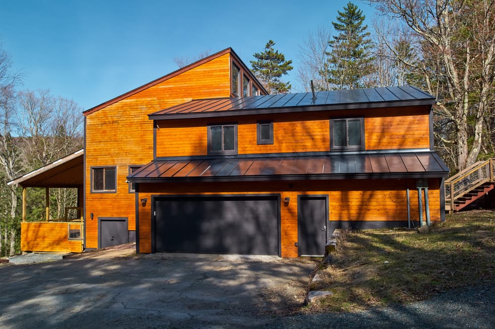 Hooks Lodge, a modern cedar-clad vacation rental in Dover, Vermont with solar panels and a standing-seam metal roof