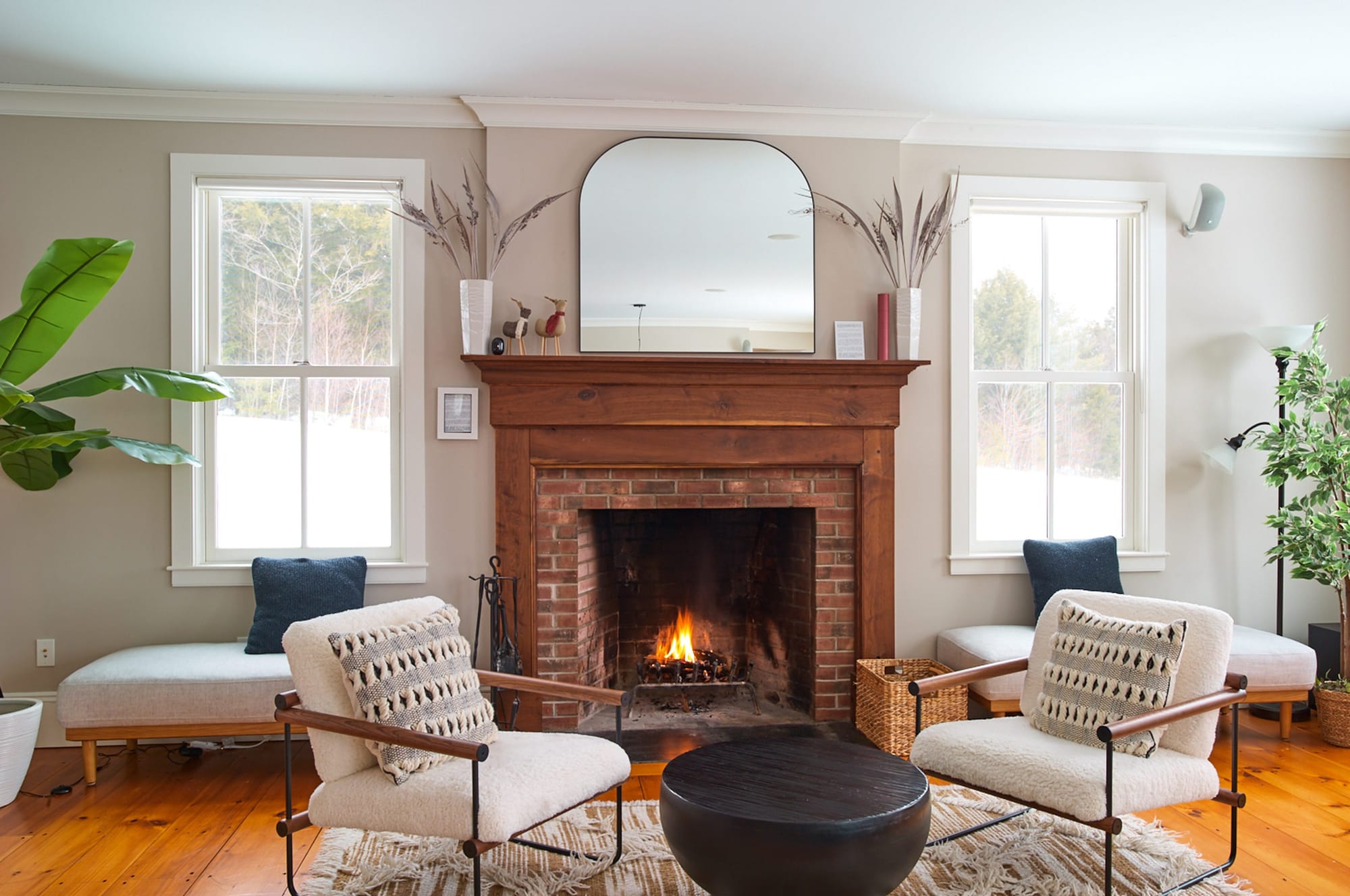 Living room with a brick fireplace and mountain views at Mellow Moose in Londonderry, Vermont